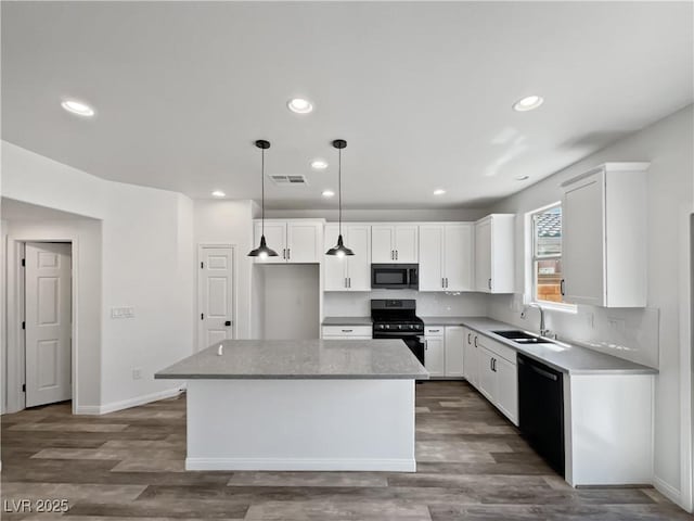 5709 Jaysin Douglas St, North Las Vegas, NV 89031 - kitchen with black appliances, a sink, a center island, white cabinets, and dark wood-type flooring