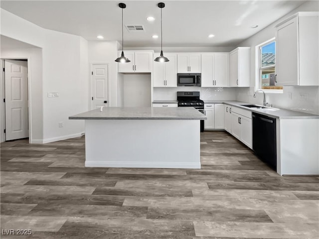 5709 Jaysin Douglas St, North Las Vegas, NV 89031 - kitchen with black appliances, a sink, a center island, white cabinetry, and recessed lighting