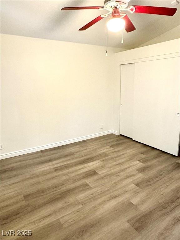 3665 Lucky Horseshoe Ct, Las Vegas, NV 89129 - unfurnished bedroom featuring wood finished floors, a closet, baseboards, and ceiling fan