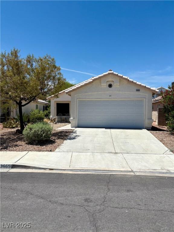 3665 Lucky Horseshoe Ct, Las Vegas, NV 89129 - ranch-style home featuring concrete driveway, stucco siding, an attached garage, and a tiled roof