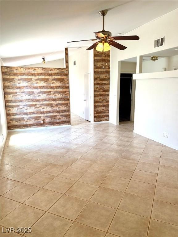 3665 Lucky Horseshoe Ct, Las Vegas, NV 89129 - unfurnished room featuring vaulted ceiling, ceiling fan, light tile patterned floors, and brick wall