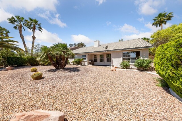 5232 Saranac Rd, Las Vegas, NV 89130 - rear view of property with a tiled roof, stucco siding, and a chimney