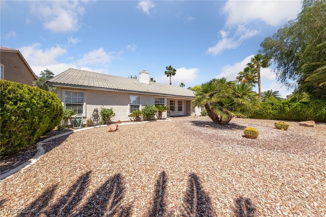 5232 Saranac Rd, Las Vegas, NV 89130 - rear view of property with a tile roof, a chimney, and stucco siding