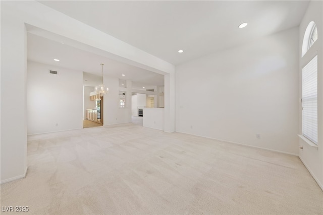 5232 Saranac Rd, Las Vegas, NV 89130 - unfurnished living room featuring a chandelier, light carpet, recessed lighting, and baseboards