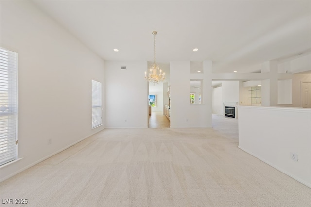 5232 Saranac Rd, Las Vegas, NV 89130 - spare room featuring a chandelier, light carpet, healthy amount of natural light, and recessed lighting