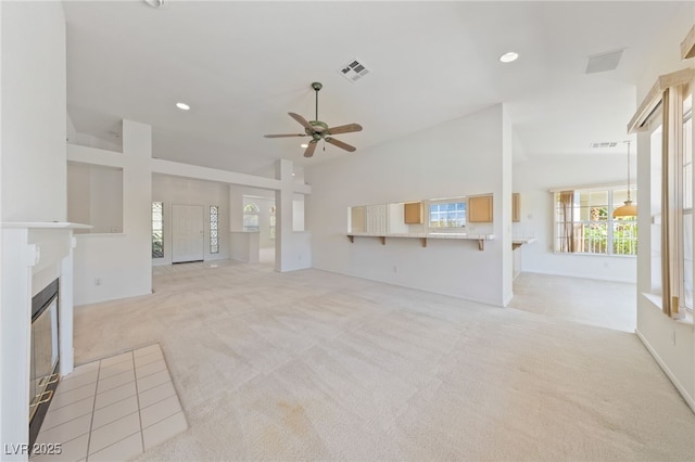 5232 Saranac Rd, Las Vegas, NV 89130 - unfurnished living room with ceiling fan, light carpet, a glass covered fireplace, recessed lighting, and high vaulted ceiling