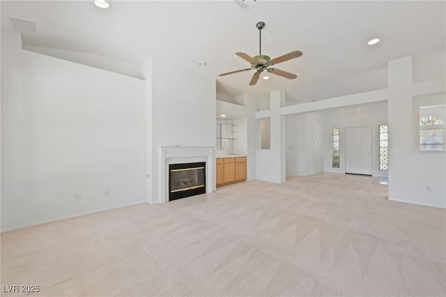 5232 Saranac Rd, Las Vegas, NV 89130 - unfurnished living room with high vaulted ceiling, light carpet, a fireplace with flush hearth, ceiling fan, and recessed lighting