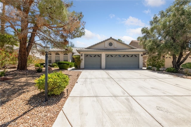 5232 Saranac Rd, Las Vegas, NV 89130 - view of front facade with a garage, driveway, stucco siding, and a tiled roof