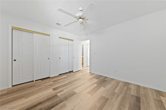 5232 Saranac Rd, Las Vegas, NV 89130 - unfurnished bedroom with two closets, light wood-style floors, baseboards, and a ceiling fan