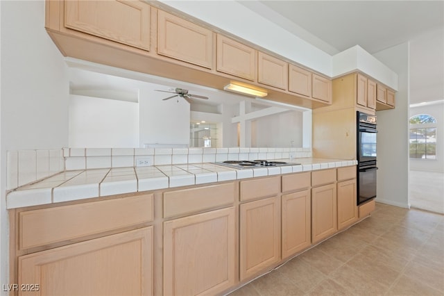 5232 Saranac Rd, Las Vegas, NV 89130 - kitchen featuring light brown cabinets, tile counters, a ceiling fan, and white stovetop