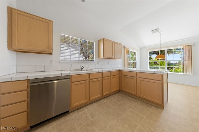 5232 Saranac Rd, Las Vegas, NV 89130 - kitchen with stainless steel dishwasher, a sink, a peninsula, vaulted ceiling, and tile countertops