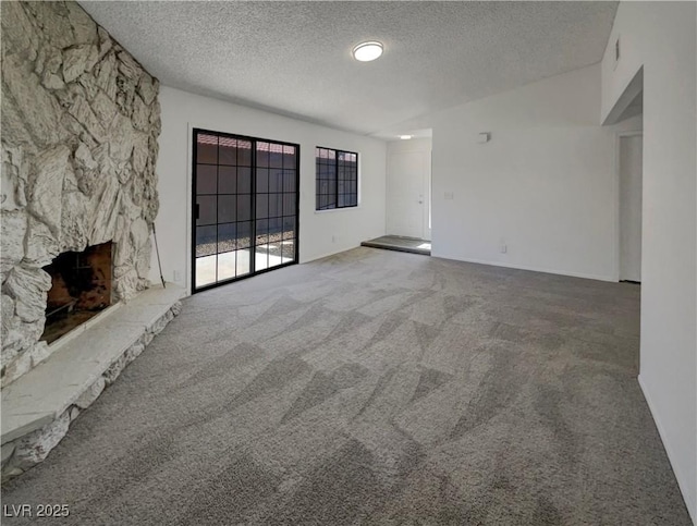 1832 Yellow Rose St, Las Vegas, NV 89108 - unfurnished living room featuring carpet flooring, a textured ceiling, and a fireplace