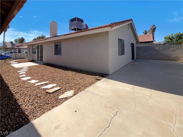 1832 Yellow Rose St, Las Vegas, NV 89108 - view of property exterior with a patio area, stucco siding, central air condition unit, and a tiled roof