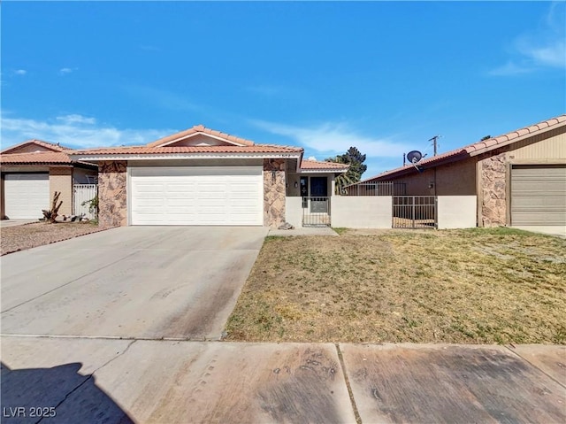 1832 Yellow Rose St, Las Vegas, NV 89108 - ranch-style house featuring a tiled roof, stone siding, an attached garage, and a gate