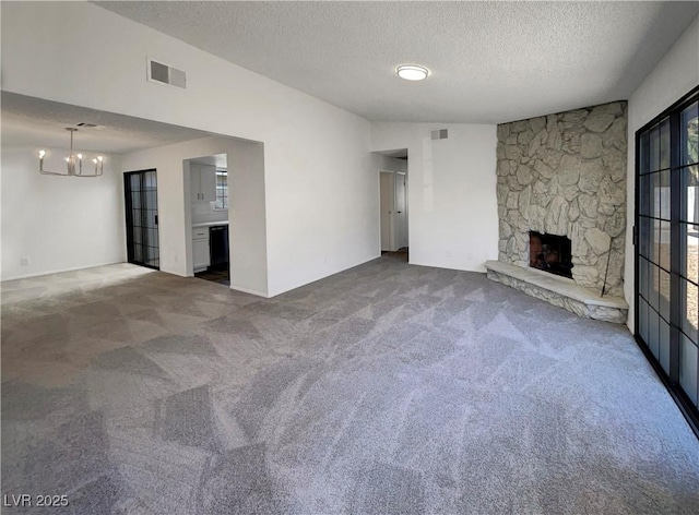 1832 Yellow Rose St, Las Vegas, NV 89108 - unfurnished living room featuring carpet, a chandelier, a textured ceiling, and a stone fireplace