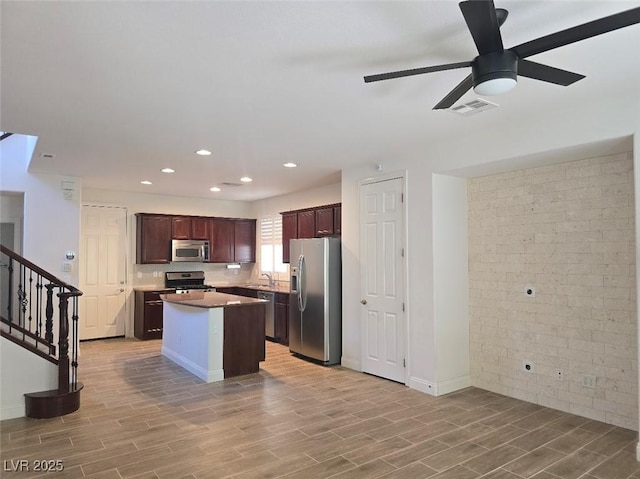 11298 Corsica Mist Ave, Las Vegas, NV 89135 - kitchen featuring appliances with stainless steel finishes, light wood-style flooring, a ceiling fan, a kitchen island, and recessed lighting