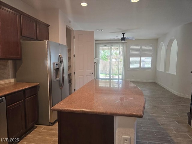 11298 Corsica Mist Ave, Las Vegas, NV 89135 - kitchen with stainless steel appliances, ceiling fan, a kitchen island, wood tiled floors, and recessed lighting