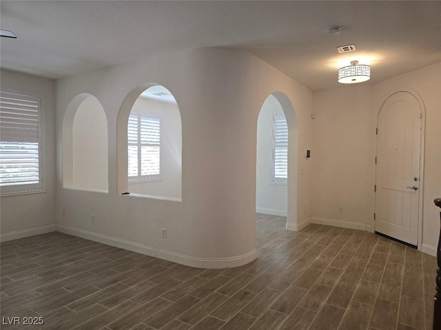 11298 Corsica Mist Ave, Las Vegas, NV 89135 - foyer with plenty of natural light, dark wood-type flooring, and arched walkways