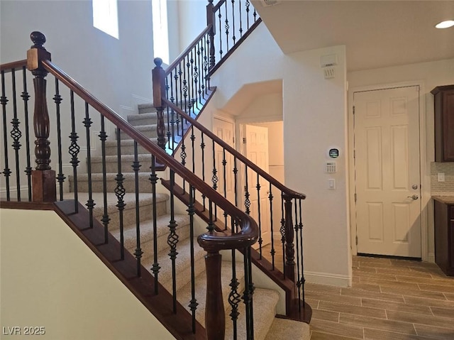 11298 Corsica Mist Ave, Las Vegas, NV 89135 - staircase featuring baseboards and wood finished floors