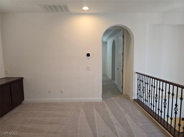 11298 Corsica Mist Ave, Las Vegas, NV 89135 - corridor with arched walkways, light colored carpet, and recessed lighting