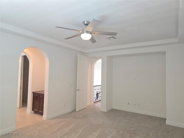 11298 Corsica Mist Ave, Las Vegas, NV 89135 - empty room with arched walkways, a ceiling fan, and light colored carpet