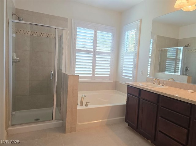 11298 Corsica Mist Ave, Las Vegas, NV 89135 - bathroom featuring tile patterned flooring, a garden tub, vanity, and plenty of natural light