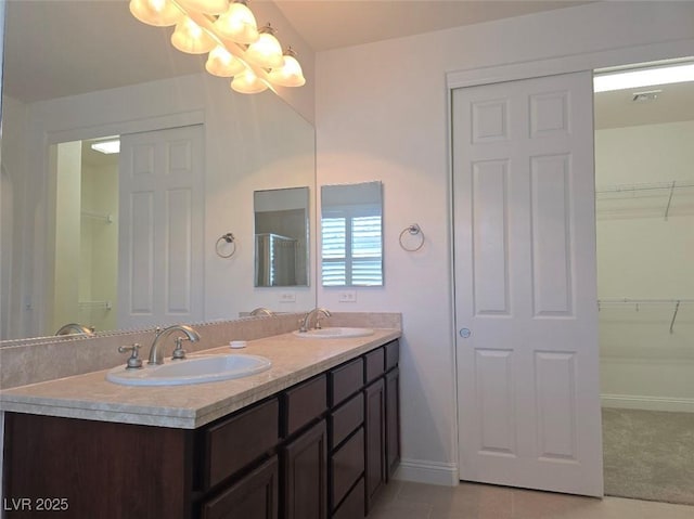 11298 Corsica Mist Ave, Las Vegas, NV 89135 - full bathroom with a chandelier, double vanity, a spacious closet, and tile patterned flooring