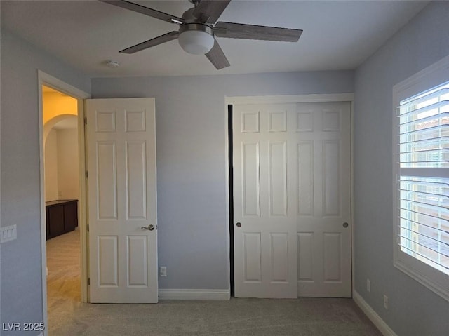 11298 Corsica Mist Ave, Las Vegas, NV 89135 - unfurnished bedroom featuring carpet floors, a closet, arched walkways, and ceiling fan