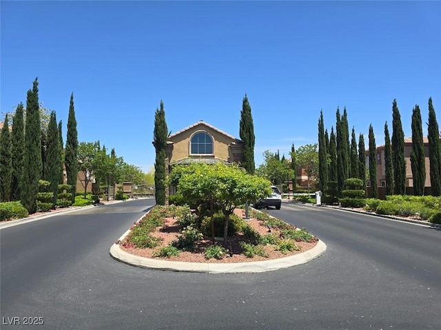 11298 Corsica Mist Ave, Las Vegas, NV 89135 - view of asphalt street with curbs and a gated entry