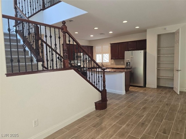 11298 Corsica Mist Ave, Las Vegas, NV 89135 - kitchen featuring stainless steel fridge with ice dispenser, recessed lighting, dark wood finished floors, dark countertops, and dark brown cabinets