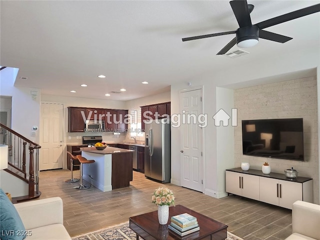 11298 Corsica Mist Ave, Las Vegas, NV 89135 - living area featuring a ceiling fan, wood finish floors, recessed lighting, and stairway
