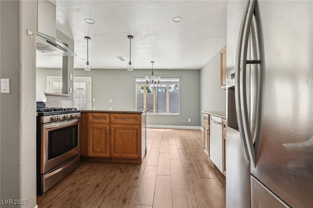 4552 Aviation St, Las Vegas, NV 89115 - kitchen with appliances with stainless steel finishes, light wood finished floors, baseboards, brown cabinetry, and wall chimney exhaust hood