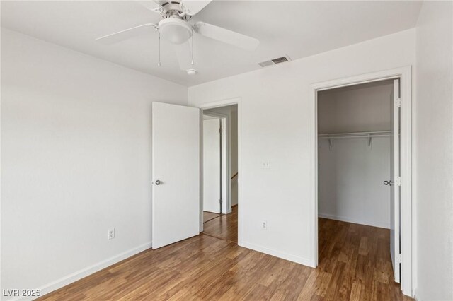 4552 Aviation St, Las Vegas, NV 89115 - unfurnished bedroom with a closet, wood finished floors, baseboards, and a ceiling fan