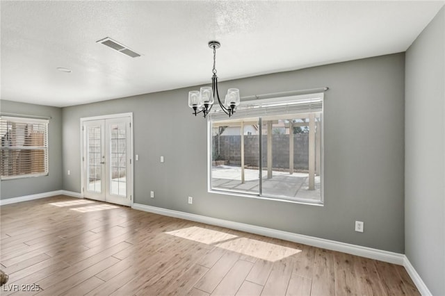 4552 Aviation St, Las Vegas, NV 89115 - unfurnished dining area with a chandelier, baseboards, and wood finished floors