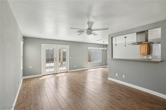 4552 Aviation St, Las Vegas, NV 89115 - unfurnished living room with ceiling fan, wood finished floors, french doors, baseboards, and a textured ceiling
