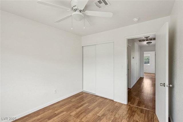 4552 Aviation St, Las Vegas, NV 89115 - unfurnished bedroom featuring wood finished floors, a closet, baseboards, and ceiling fan