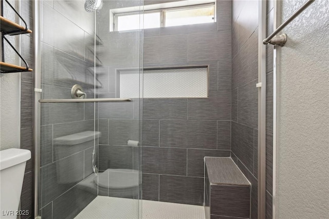 4552 Aviation St, Las Vegas, NV 89115 - bathroom featuring toilet, a shower stall, and a textured wall