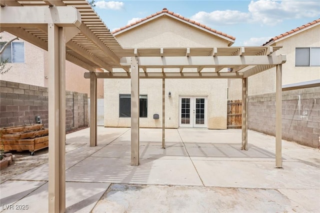 4552 Aviation St, Las Vegas, NV 89115 - fenced backyard with french doors, a pergola, and a patio
