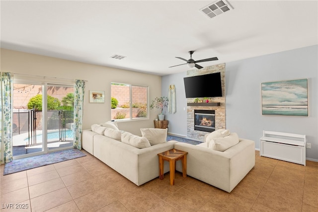 11226 Kenyan Sunshine Ct, Las Vegas, NV 89138 - living room featuring a fireplace, a ceiling fan, and light tile patterned floors