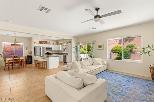 11226 Kenyan Sunshine Ct, Las Vegas, NV 89138 - living area with ceiling fan, light tile patterned floors, and baseboards
