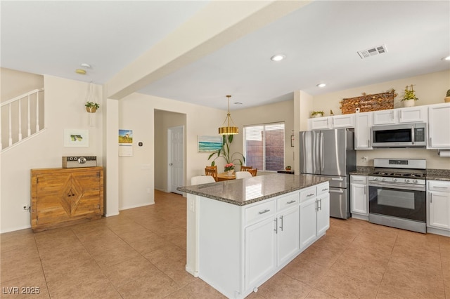 11226 Kenyan Sunshine Ct, Las Vegas, NV 89138 - kitchen with appliances with stainless steel finishes, dark stone countertops, white cabinetry, and recessed lighting