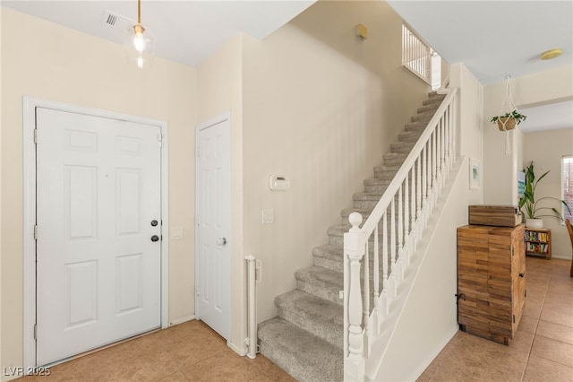 11226 Kenyan Sunshine Ct, Las Vegas, NV 89138 - entrance foyer with light tile patterned flooring, stairway, and baseboards