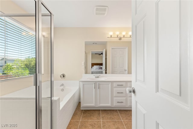 11226 Kenyan Sunshine Ct, Las Vegas, NV 89138 - ensuite bathroom featuring vanity, a garden tub, tile patterned flooring, and a stall shower