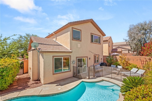 11226 Kenyan Sunshine Ct, Las Vegas, NV 89138 - rear view of property featuring a tiled roof, stucco siding, a patio area, and a fenced backyard