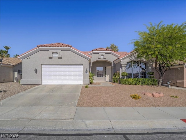 401 Obsidian St, Las Vegas, NV 89145 - mediterranean / spanish house with a tile roof, stucco siding, an attached garage, and concrete driveway