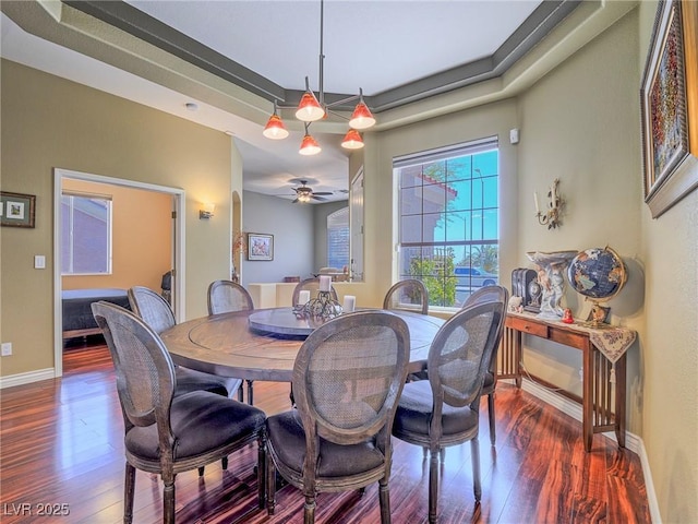 401 Obsidian St, Las Vegas, NV 89145 - dining area featuring dark wood-style flooring, baseboards, a ceiling fan, and a tray ceiling