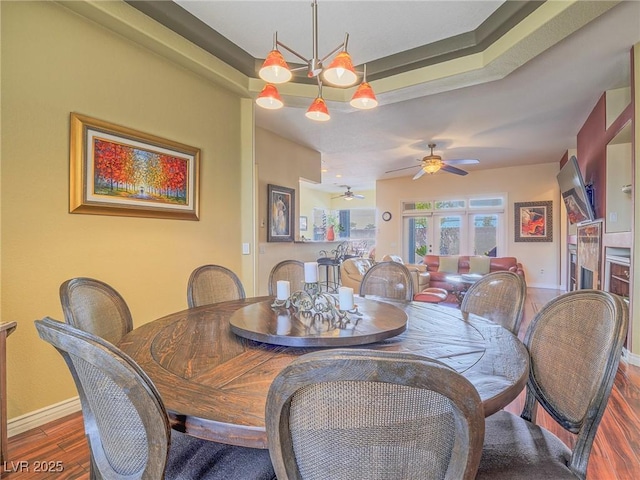 401 Obsidian St, Las Vegas, NV 89145 - dining room with wood finished floors, a ceiling fan, and baseboards