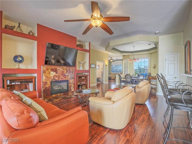 401 Obsidian St, Las Vegas, NV 89145 - living room featuring ceiling fan, a tray ceiling, and baseboards