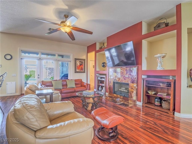 401 Obsidian St, Las Vegas, NV 89145 - living area featuring wood finished floors, a ceiling fan, a high end fireplace, baseboards, and french doors