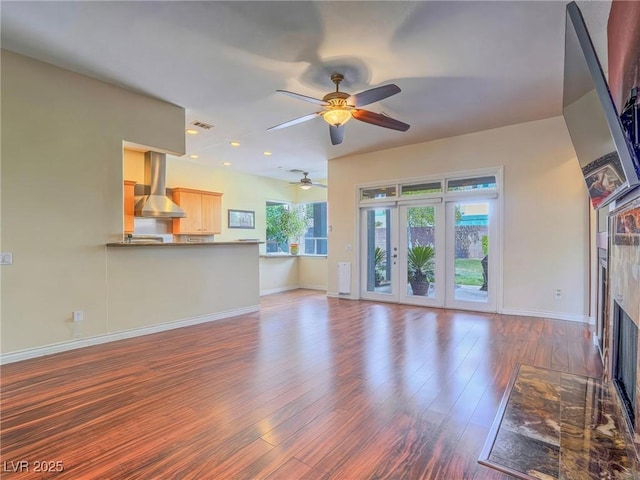 401 Obsidian St, Las Vegas, NV 89145 - unfurnished living room with ceiling fan, baseboards, wood finished floors, a tile fireplace, and recessed lighting